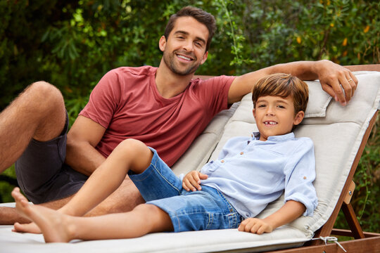 Relax, dad and boy in backyard with portrait, family connection and chill together on day off. Rest, parent and child outdoor with healthy relationship, happy moment and good mood on weekend break.