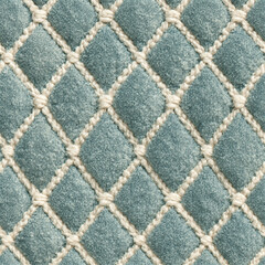 Obraz premium Seamless pattern quilted teal velvet fabric creating a diamond pattern, soft textile with woven cream thread details, elegant upholstery texture background