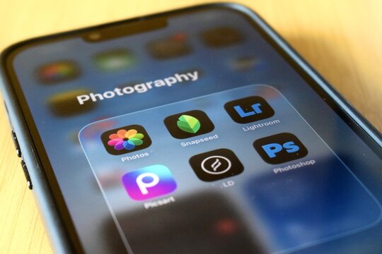 Sarawak, Malaysia - 9 August 2026: Close-up of a smartphone screen displaying a organized photography app folder featuring Lightroom, Photoshop, and Picsart icons.