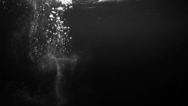 Black and white underwater explosion with bubbles, abstract visual effect, water motion background