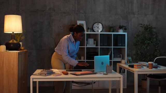 Businesswoman finishing work late in the office at night