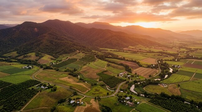 Aerial sunset over North Queensland mountains and agricultural fields, Australia