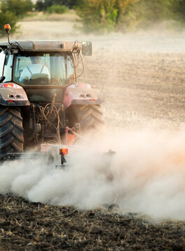 Farmer in tractor preparing land for sowing