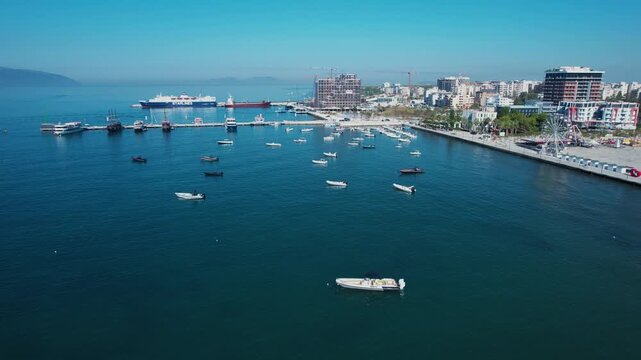 Passenger ferries and seaside boats anchored together on a quiet sea near the harbor