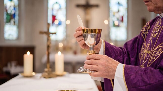Priest holding chalice during religious ceremony in church.