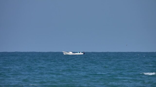 A white felucca, motor schooner in the Arabian Sea. The coastal schooner Oman