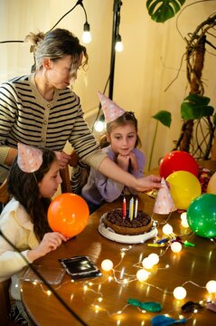 Celebrating a joyful birthday party with colorful decorations and joyful moments in a cozy indoor setting during the evening hours