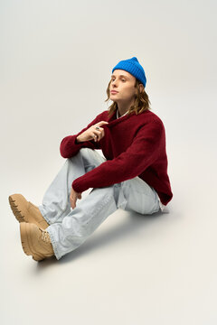 Stylish young man embodies modern fashion in blissful artistic setting