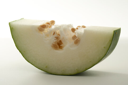 close up of sliced winter melon with white flesh and seeds