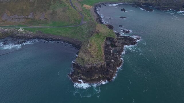 Aerial view of the rugged basalt cliffs of the Giant's Causeway along the Atlantic coastline in Bushmills, Northern Ireland, United Kingdom.