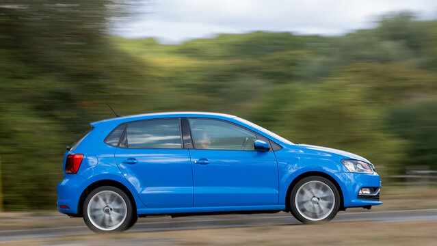 Milton Keynes; UK - Aug 30th 2026: 2014 blue Volkswagen Polo hatchback car driving on a British road