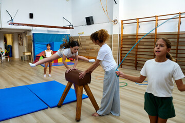 Girls practicing gymnastics vaulting and skipping rope in gym © alvaro