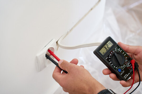 Testing wall outlet voltage with digital multimeter