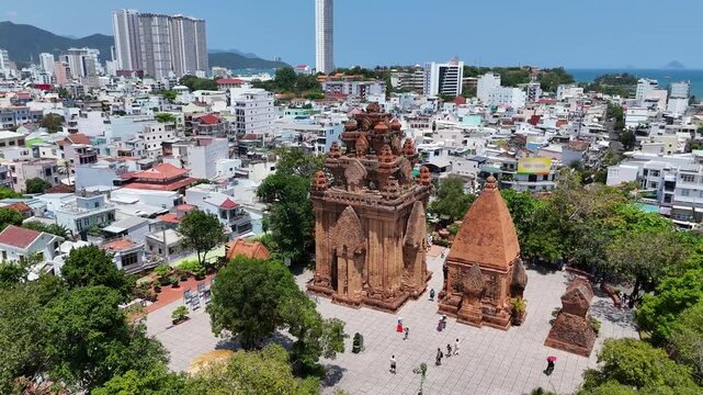 Ancient Cham Ponagar (Po Nagar) towers on green hill and Nha Trang city panorama, Vietnam.