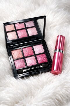 Glamorous cosmetic makeup kit featuring rose gold compact case applicator and lipstick