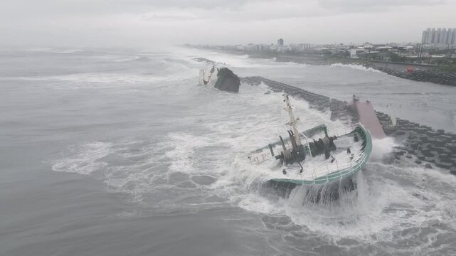 Aerial Footage Of Shipwreck Surrounded By Rough Seas And Large Waves
