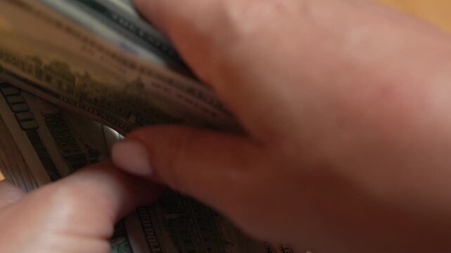 Money, cash, currency, hands counting stack of hundred dollar bills for financial transactions and economic investment in business office setting