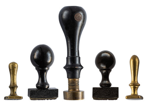 Collection of five antique rubber and metal stamps, seals and vintage stamping tools, isolated on a white background. Assorted historic designs with black wooden handles and aged brass details.