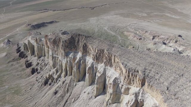 Aerial view of the dramatic limestone cliffs and arid desert landscape of the Mangystau Safari area near Aktau, Mangystau Region, Kazakhstan.