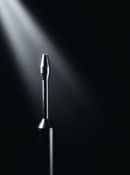 A sample probe standing in a shaft of light in still filtered air