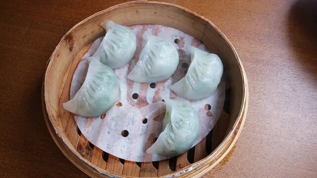 Steamed Korean dumplings filled with pork and vegetables, close-up image.