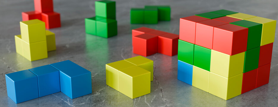 Colorful geometric blocks arranged on a textured surface, representing logic and strategy