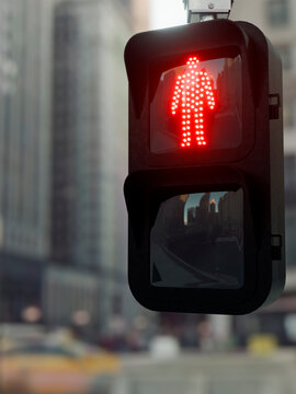 Red pedestrian signal illuminated, indicating stop for walkers in urban setting