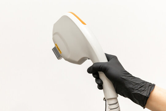 Aesthetic Laser Treatments concept. Doctor hand with laser device, white background. Innovative non-ablative fractional technology for skin photo rejuvenation. Cellular renewal, collagen synthesis