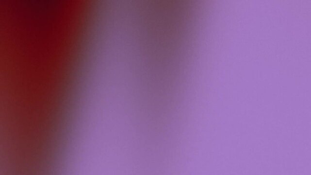 Grainy purple and red gradient background with soft blurred texture