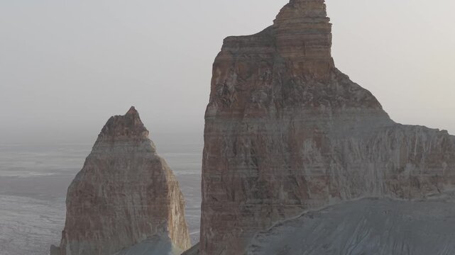 Aerial view of the dramatic limestone rock formations of Bozjyra, with rugged cliffs and desert landscape in Aktau, Mangystau Region, Kazakhstan.