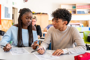 Diverse students collaborating on assignment in classroom learning © unai