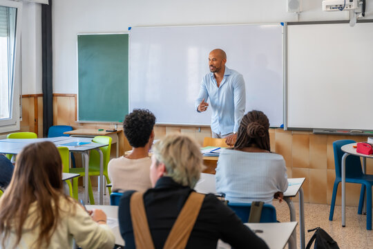 Teacher educating diverse students in modern classroom setting
