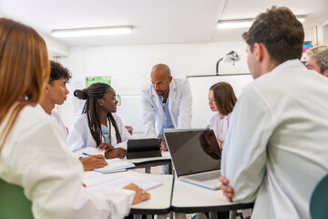 Fototapeta premium Diverse students and professor collaborating during science class
