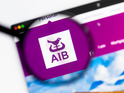 Milan, Italy 2026, 15 AGO Closeup of AIB Group website page on a laptop screen. Focus on AIB Group logo under a magnifying glass.