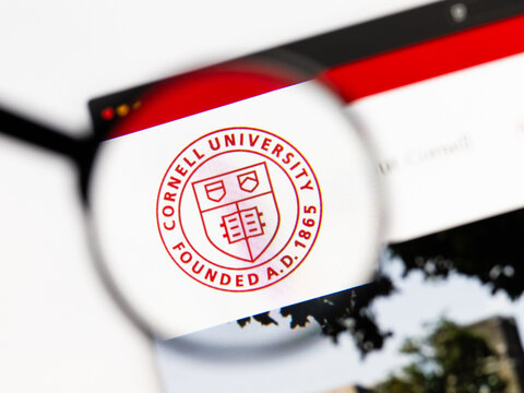 Milan, Italy 2026, 15 AGO Closeup of cornell university website page on a laptop screen. Focus on cornell university logo under a magnifying glass.
