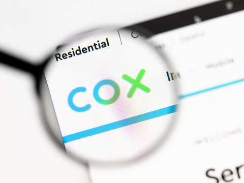 Milan, Italy 2026, 15 AGO Closeup of cox net website page on a laptop screen. Focus on cox net logo under a magnifying glass.