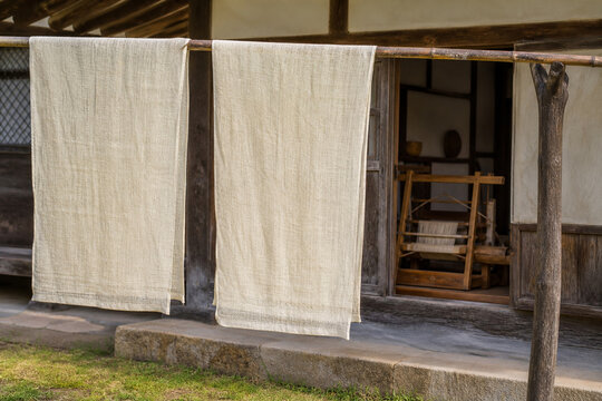 Korean ramie fabric drying beside a traditional house