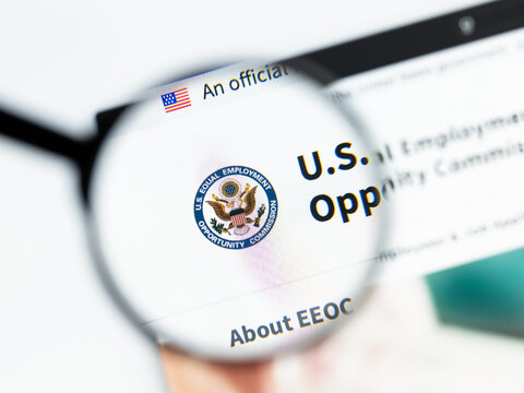 Milan, Italy 2026, 15 AGO Closeup of Equal Employment Opportunity Commission EEOC website page on a laptop screen. Focus on Equal Employment Opportunity Commission EEOC logo under a magnifying glass.