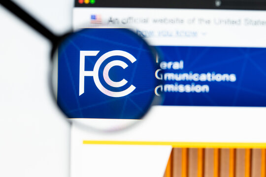 Milan, Italy 2026, 15 AGO Closeup of Federal Communications Commission FCC website page on a laptop screen. Focus on Federal Communications Commission FCC logo under a magnifying glass.