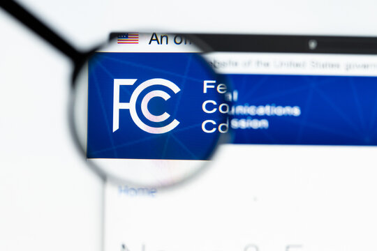 Milan, Italy 2026, 15 AGO Closeup of Federal Communications Commission FCC website page on a laptop screen. Focus on Federal Communications Commission FCC logo under a magnifying glass.