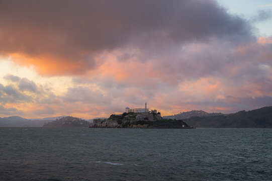 Alcatraz island at colorful sunset. Copy space travel banner 