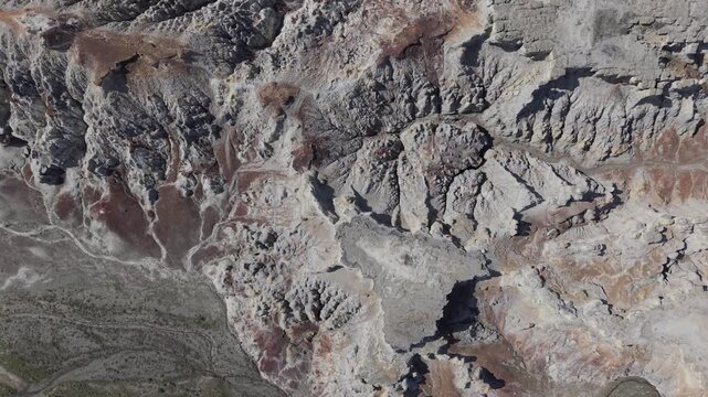 Aerial view of rocky desert landscape with textured canyons and arid terrain in Aktau, Mangystau Region, Kazakhstan.