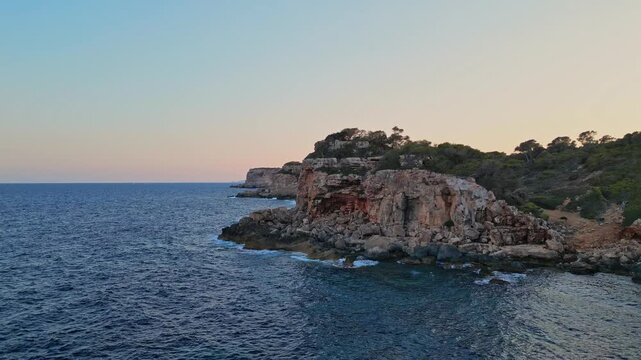 Aerial travel fooatge of waves crashing on shore, Spanish coastline, Mallorca coast. Summer, travel,vacation concept. 