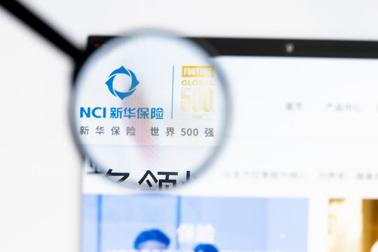 Milan, Italy 2026, 15 AGO Closeup of New China Life Insurance website page on a laptop screen. Focus on New China Life Insurance logo under a magnifying glass.