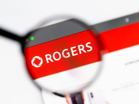 Milan, Italy 2026, 15 AGO Closeup of Rogers Communications website page on a laptop screen. Focus on Rogers Communications logo under a magnifying glass.