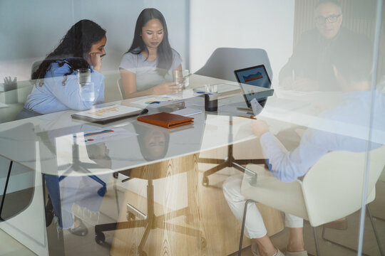 Multiracial colleagues working inside business office with glass walls - Brainstorming concept - Main focus on african girl face - UGC content