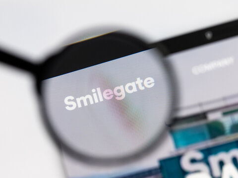 Milan, Italy 2026, 15 AGO Closeup of Smilegate website page on a laptop screen. Focus on Smilegate logo under a magnifying glass.