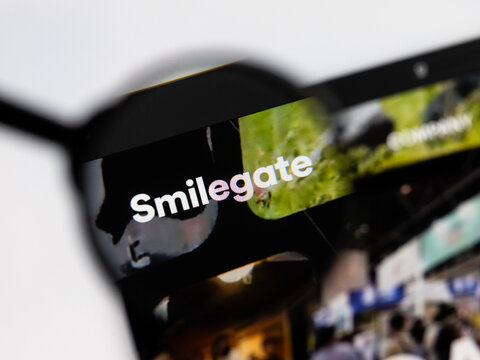 Milan, Italy 2026, 15 AGO Closeup of Smilegate website page on a laptop screen. Focus on Smilegate logo under a magnifying glass.