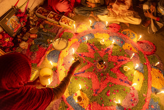View of a vibrant rangoli pattern decorated with lit diyas during the Diwali festival celebration in Rahim Yar Khan, Punjab, Pakistan.