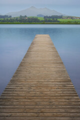 Obraz premium Wooden pier extending into Hopfensee lake in Bavaria